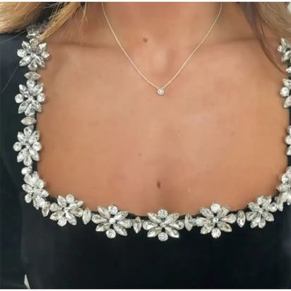 detailed close up of sparkly jewel trim on black velvet christmas dress